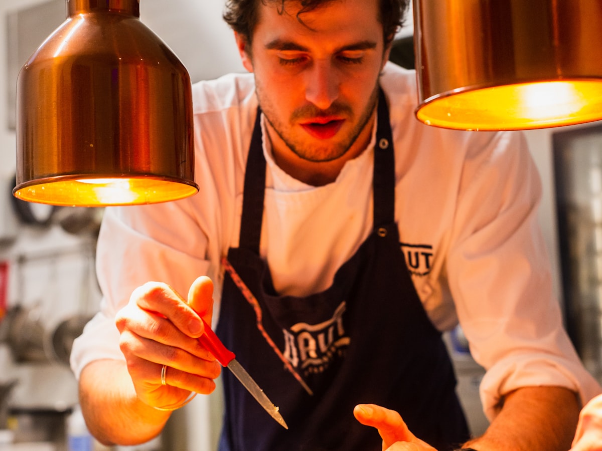 Chef plating a dish at the pass